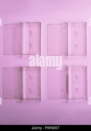 Vintage Still Life. Set of old cassettes covers on a light pink surface View from above. Stock Photo