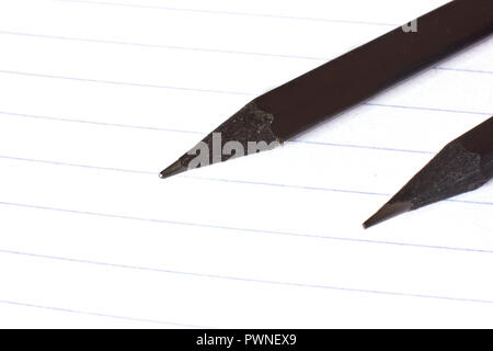 Black pencils on a white line paper Stock Photo