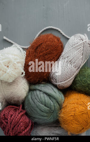 Variety of knitting yarns on grey background. Top view Stock Photo