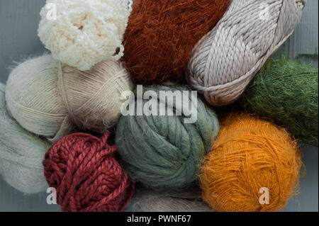 Variety of knitting yarns on grey background. Top view Stock Photo