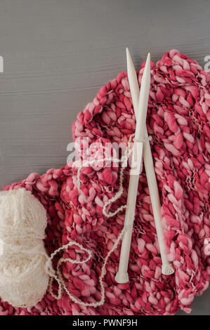 Variety of knitting yarns and knitting needles on grey background. Top view Stock Photo