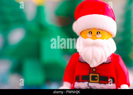Tambov, Russian Federation - September 02, 2018 Portrait of Lego Santa Claus against Christmas trees. Close-up. Stock Photo