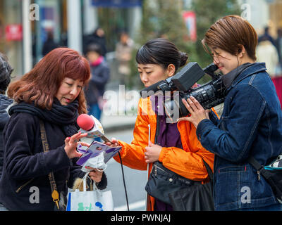 Ginza Shopping Video - Japanese TV crew interview shoppers in the upmarket Ginza Shopping district in Tokyo Japan Stock Photo