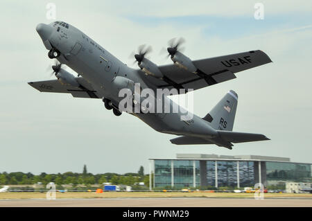 Lockheed C-130J Hercules leaping into the air. Steep climb taking off from Farnborough runway. United States Air Force. USAF. US Air Force Stock Photo