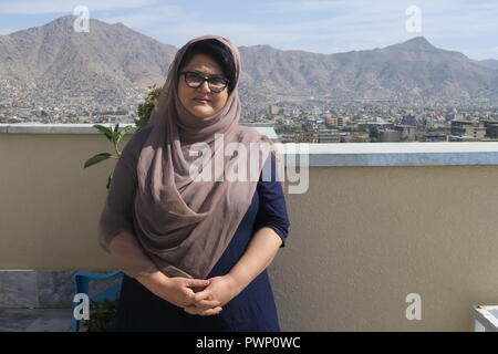 Kabul, Afghanistan. 13th Oct, 2018. Hilai Irschad, an Afghan parliamentarian, stands on the terrace of her apartment in southern Kabul. Irschad was previously for the minority of Kuchi nomads in parliament, now she is running for a seat in the province of Kabul. Credit: Veronika Eschbacher/dpa/Alamy Live News Stock Photo