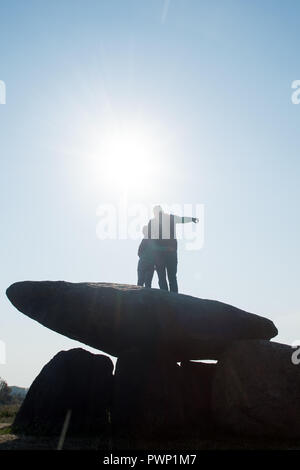 17 October 2018, Saxony-Anhalt, Drosa: 17 October 2018, Germany, Drosa: A father shows his son the surrounding countryside and stands on the big stone tomb Teufelskeller. The ground monument dates back to the Neolithic period. In the morning, the monument information system of Saxony-Anhalt was released on the Internet. The website lists all monuments of the federal state, shows its position on the map and gives basic information about the respective monument. The data had been collected over many years by the State Office for Monument Preservation and Archaeology. Photo: Klaus-Dietmar Gabbert Stock Photo