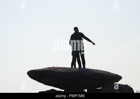 17 October 2018, Saxony-Anhalt, Drosa: 17 October 2018, Germany, Drosa: A father shows his son the surrounding countryside and stands on the big stone tomb Teufelskeller. The ground monument dates back to the Neolithic period. In the morning, the monument information system of Saxony-Anhalt was released on the Internet. The website lists all monuments of the federal state, shows its position on the map and gives basic information about the respective monument. The data had been collected over many years by the State Office for Monument Preservation and Archaeology. Photo: Klaus-Dietmar Gabbert Stock Photo