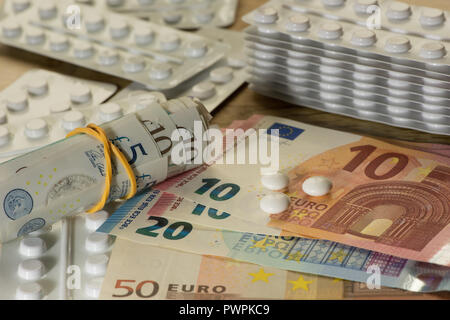 Money Sterling or Euros paid for prescription only medical drugs medicine on black market, illegal to sell pills, capsules, blister packets Stock Photo