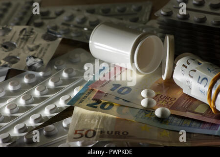 Money Sterling or Euros paid for prescription only medical drugs medicine on black market, illegal to sell pills, capsules, blister packets Stock Photo