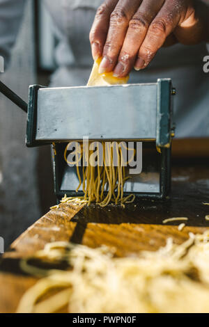 A WOMAN MAKING HOMEMADE PASTA IN THE TRADITIONAL WAY Stock Photo