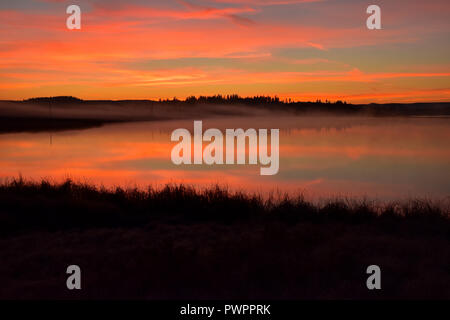 Beautiful sunrise on Watson Lake just north of 100 Mile House, BC, Canada. Taken around 7:20 AM Stock Photo