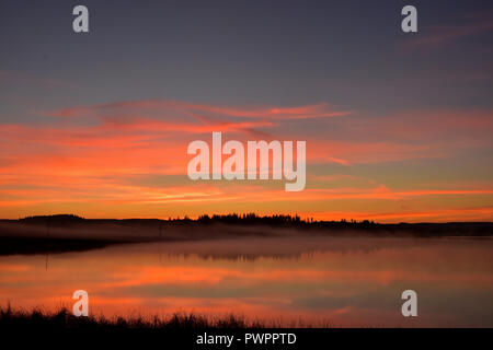 Beautiful sunrise on Watson Lake just north of 100 Mile House, BC, Canada. Taken around 7:20 AM Stock Photo