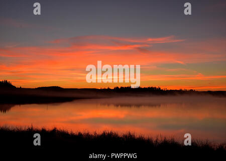 Beautiful sunrise on Watson Lake just north of 100 Mile House, BC, Canada. Taken around 7:20 AM Stock Photo