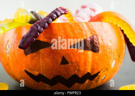 Pumpkin Jack with candies like hair, closeup view, Halloween concept Stock Photo