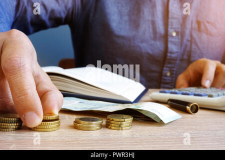 Man is counting euro coins. Home finances and budgeting. Stock Photo