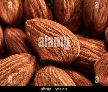 Organic texture of almonds. View from above. Almonds macro background. Almond nuts with soft focus. Stock Photo