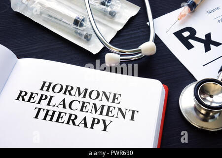 Book about Hormone Replacement Therapy and syringes. Stock Photo