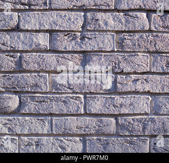 wall of white weathered bricks with shadows. background, texture. Stock Photo