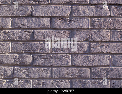 wall of white weathered bricks with shadows. background, texture. Stock Photo