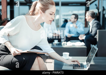 Profile photo of delighted woman that using laptop Stock Photo