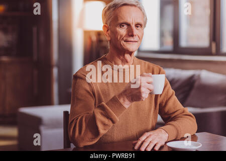 Smiling man having tea an relaxing Stock Photo