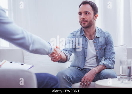 Satisfied man expressing gratitude to his personal psychiatrist Stock Photo