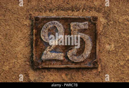 Old retro weathered cast iron plate with number 25 closeup Stock Photo