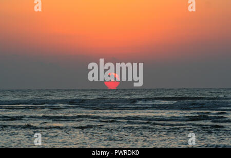 A brilliant sunrise with dramatic clouds over the Atlantic Ocean. Stock Photo