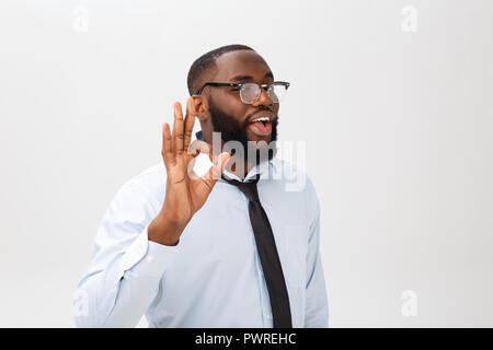 Young black businessman having happy look, smiling, gesturing, showing OK sign. African male showing OK-gesture with his fingers. Body language concept. Stock Photo