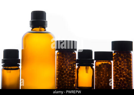 Bottles and pills of homeopathic medicine / remedies studio shot against white background Stock Photo