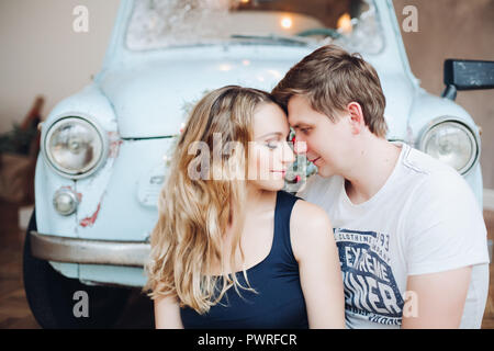 Lovely husband standing from back and embracing beautiful blonde woman. Stock Photo