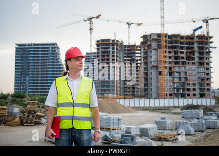 Engineer on a construction site working on housing project Stock Photo