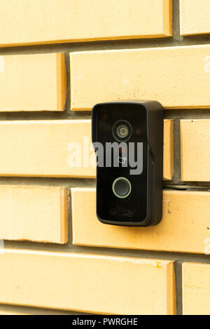 bell with a video camera on a brick wall Stock Photo