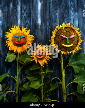three sunflowers on wooden table Stock Photo