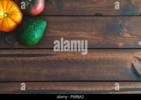 Assorted fresh vegetables on a brown table great for farm-to-table messaging. Stock Photo