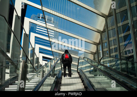 17.09.2018, Sydney, New South Wales, Australia - A man is seen standing on an escalator that leads to the sheltered Barangaroo Pedestrian Bridge. Stock Photo