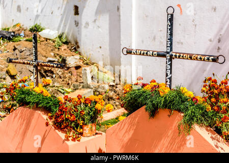 Santiago Sacatepequez, Guatemala - November 1, 2017: Grave decorated with flowers for All Saints Day in Guatemala. Stock Photo