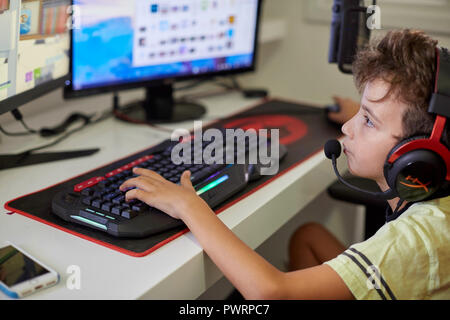 Israel Tel Aviv October 15, 2018: Teenager playing Fortnite video game on PC. Fortnite is an online multiplayer video game developed by Epic Games Stock Photo