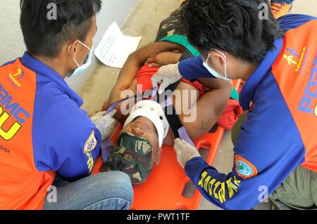 Members of the provincial Disaster Risk Reduction Management Office demonstrate their response capabilities during a mass casualty exercise at Bogo City Hall, Northern Cebu Province, Philippines, June 25, 2017. As part of Pacific Angel 2017, local first responders worked together with U.S. and Philippine forces to share and teach best practices in public health, mass casualty response and other relevant topics. Stock Photo