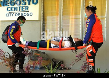 Members of the provincial Disaster Risk Reduction Management Office carry a volunteer as part of a mass casualty exercise at Bogo City Hall, Northern Cebu Provice, Philippines, June 25, 2017. As part of Pacific Angel 2017, local first responders worked together with U.S. and Philippine forces to share and teach best practices in public health, mass casualty response and other relevant topics. Stock Photo