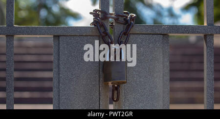Closed double gates with chain and padlock Stock Photo