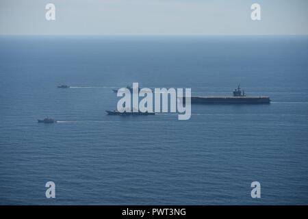 ATLANTIC OCEAN (June 27, 2017) The aircraft carrier USS Dwight D. Eisenhower (CVN 69)(Ike), the Arleigh Burke-class guided-missile destroyer USS Winston S. Churchill (DDG 81), the guided-missile cruiser USS San Jacinto (CG 56), the Royal Canadian Navy Kingston-class maritime coastal defense vessel HMCS Glace Bay (MM 701), and the Royal Canadian Navy Kingston-class maritime coastal defense vessel HMCS Moncton (MM 708) transit the Atlantic Ocean during a photo exercise. The ships are underway conducting a bilateral group sail as part of the Canada 150 anniversary celebration. ( Stock Photo