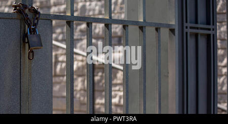 Double gates with chain and padlock on a sunny day Stock Photo