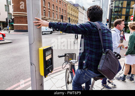 London England,UK,Southwark,street pedestrian crossing,crosswalk,signal activation box,cyclist,bicycle bicycles bicycling riding biking rider riders b Stock Photo