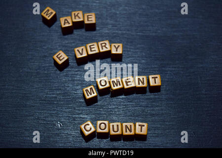 Make every moment count message written on wooden blocks. Motivation concepts. Cross processed image Stock Photo