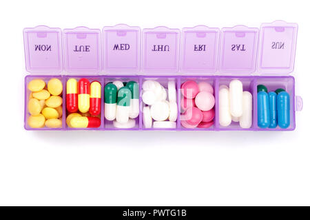 Daily pill box with medical pills isolated on white background. Top view. Flat lay. Stock Photo