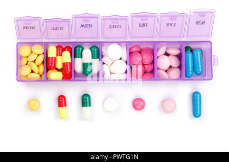 Daily pill box with medical pills isolated on white background. Top view. Flat lay. Stock Photo
