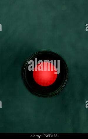 A photo of a vibrant red button, shot from above, a kill switch on a dark panel with a place for text Stock Photo