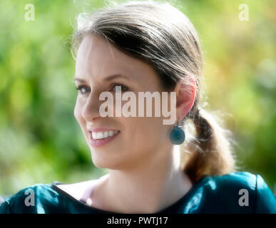 Young woman smiles, portrait, Germany Stock Photo