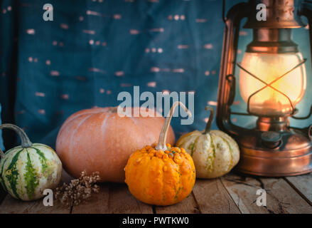 Mini pumpkins and lantern on wooden background Stock Photo